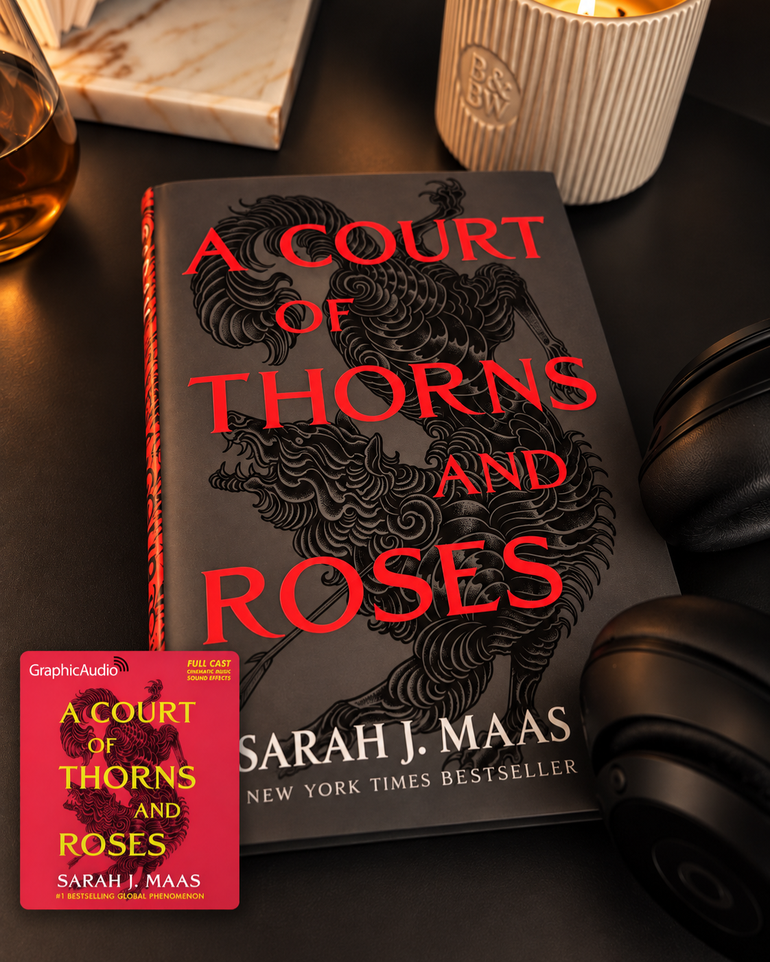 A Court of Thorns and Roses book beside headphones and candlelight